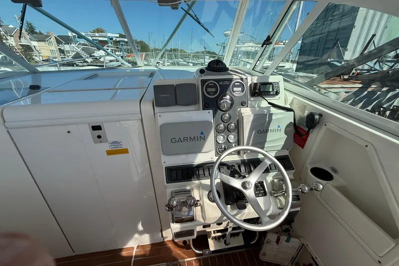 Slide: The Image of Cockpit of 2002 Rampage 30 Express boat with Garmin navigation system and steering wheel. - 11
