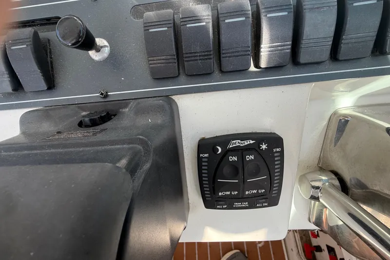 Slide: The Image of Control panel of a 2002 Rampage 30 Express boat with trim tab switches. - 13
