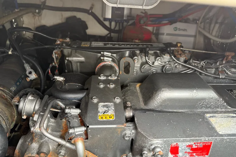 Slide: The Image of Engine compartment of a 2002 Rampage 30 Express boat, showing mechanical components and wiring. - 28