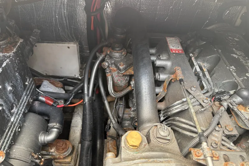 Slide: The Image of Engine compartment of a 2002 Rampage 30 Express boat, showing mechanical components and wiring. - 30