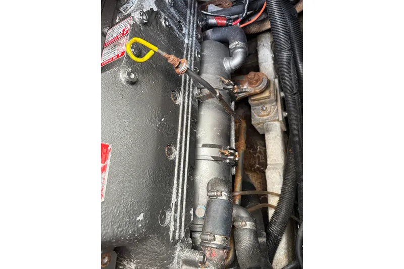 Slide: The Image of Engine compartment of a 2002 Rampage 30 Express boat, showing mechanical components and wiring. - 31