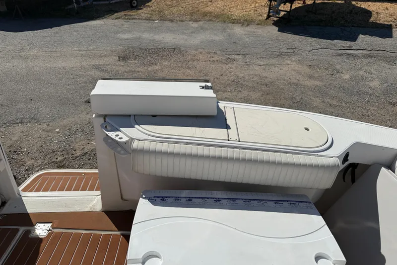 Slide: The Image of 2002 Rampage 30 Express boat deck with seating and storage compartments. - 5