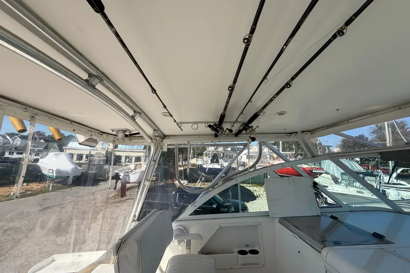 Slide: The Image of Interior view of 2002 Rampage 30 Express boat with fishing rods mounted on the ceiling. - 6