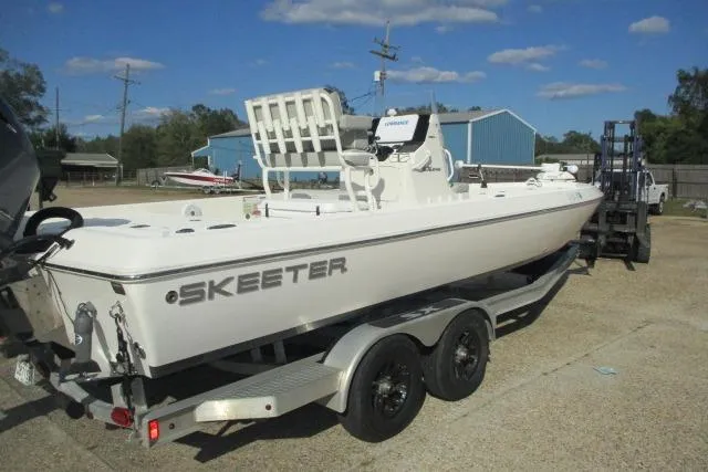 The Image of 2021 Skeeter SX240 boat on trailer in outdoor setting, clear sky background. - 0