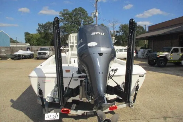 Slide: The Image of 2021 Skeeter SX240 boat with Yamaha 300 engine, parked outdoors. - 8