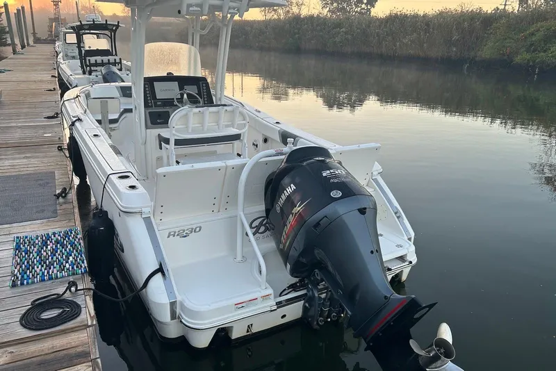 Slide: The Image of 2020 Robalo R230 Center Console boat docked with Yamaha outboard motor. - 12