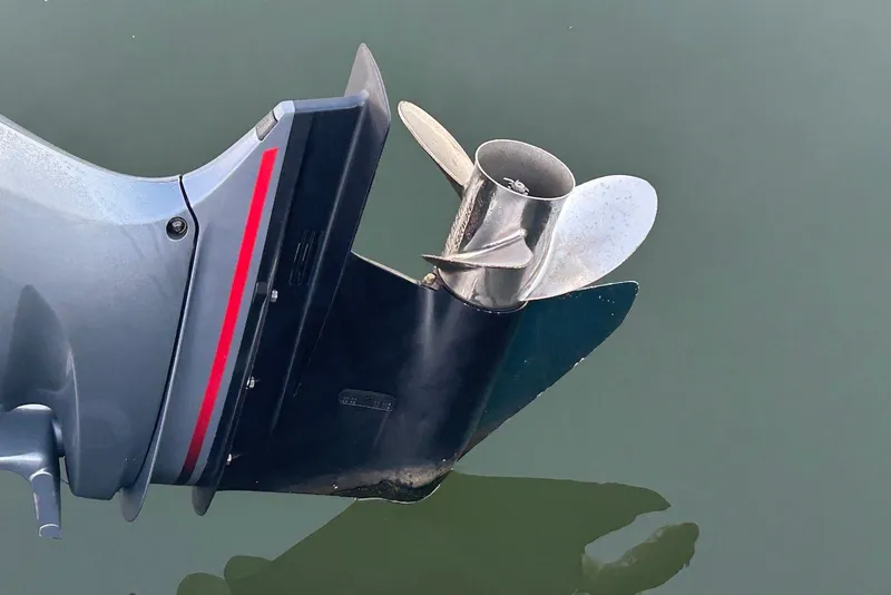 Slide: The Image of Outboard motor propeller of 2020 Robalo R230 Center Console boat in water. - 14