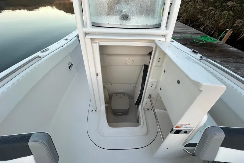 Slide: The Image of 2020 Robalo R230 Center Console boat with open storage compartment. - 7