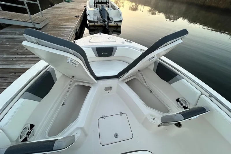 Slide: The Image of 2020 Robalo R230 Center Console boat with open storage compartments at dock. - 8