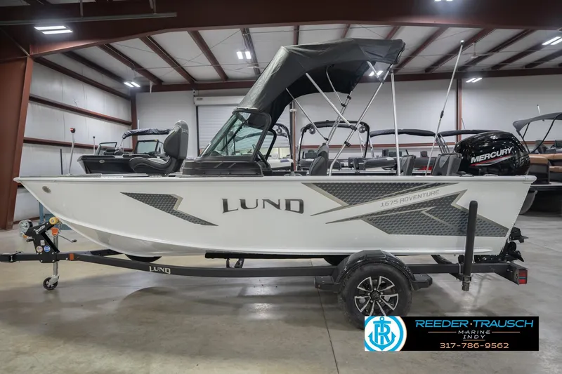 Slide: The Image of 2026 Lund 1675 Adventure Sport boat in showroom with Mercury engine. - 11