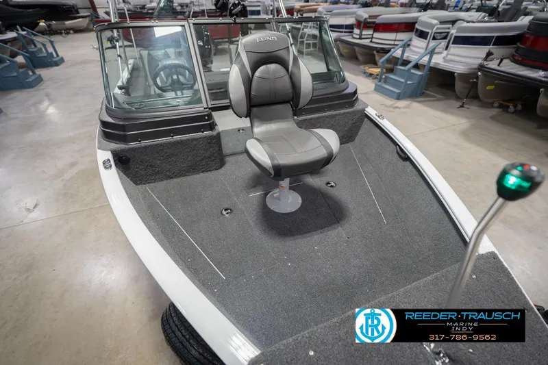 Slide: The Image of 2026 Lund 1675 Adventure Sport boat interior with seating, displayed in showroom. - 13