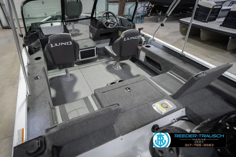 Slide: The Image of 2026 Lund 1675 Adventure Sport boat interior with seating and steering console. - 15