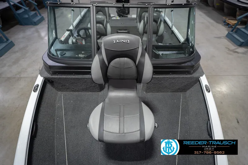Slide: The Image of 2026 Lund 1675 Adventure Sport boat interior with gray seating and windshield. - 19