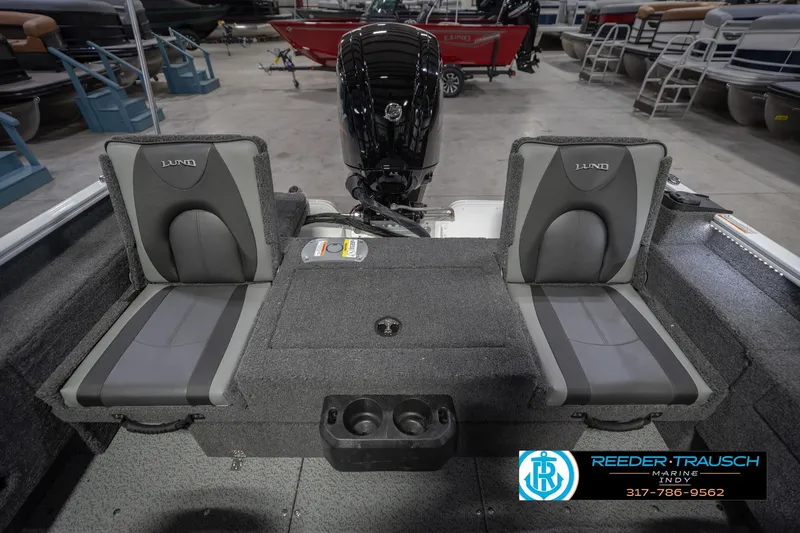 Slide: The Image of 2026 Lund 1675 Adventure Sport boat interior with dual seats and motor, displayed at Reeder-Trausch Marine. - 21