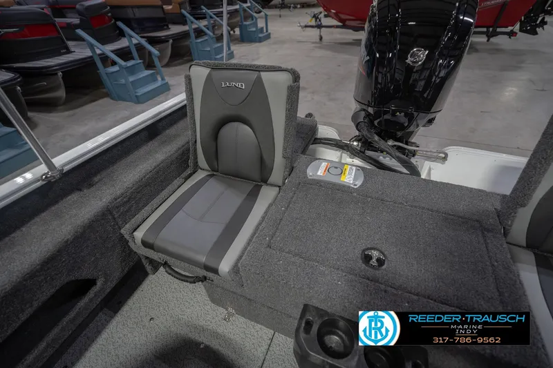 Slide: The Image of 2026 Lund 1675 Adventure Sport boat interior with seating and motor, displayed at Reeder-Trausch Marine. - 22