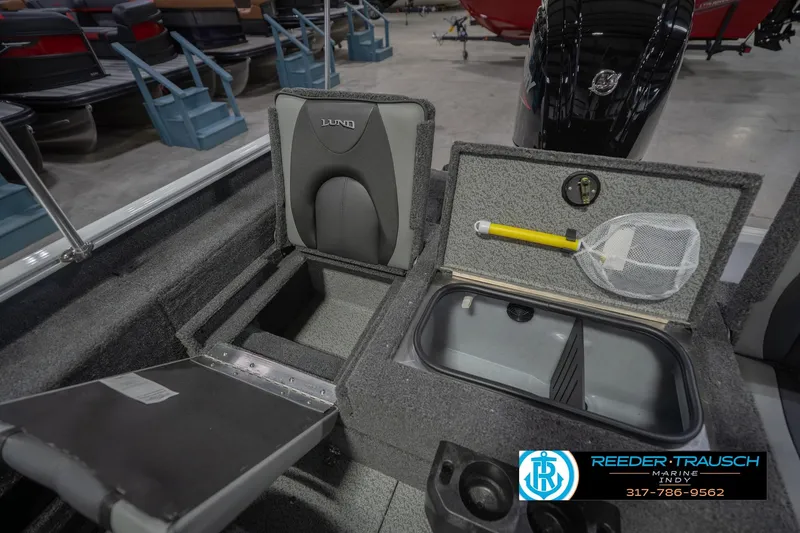 Slide: The Image of 2026 Lund 1675 Adventure Sport boat interior with storage compartments and fishing net. - 24