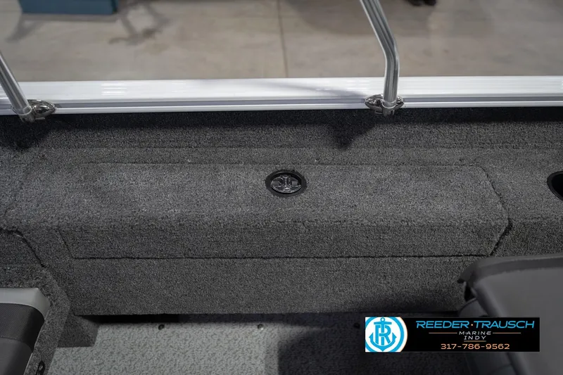Slide: The Image of 2026 Lund 1675 Adventure Sport boat interior with gray carpet and storage compartment. - 25