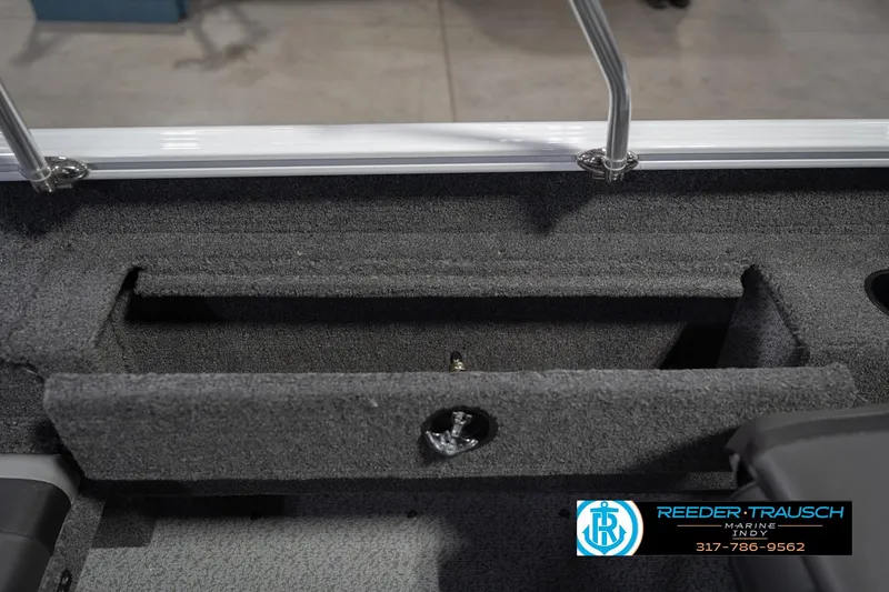 Slide: The Image of 2026 Lund 1675 Adventure Sport boat interior storage compartment, Reeder-Trausch Marine logo visible. - 26