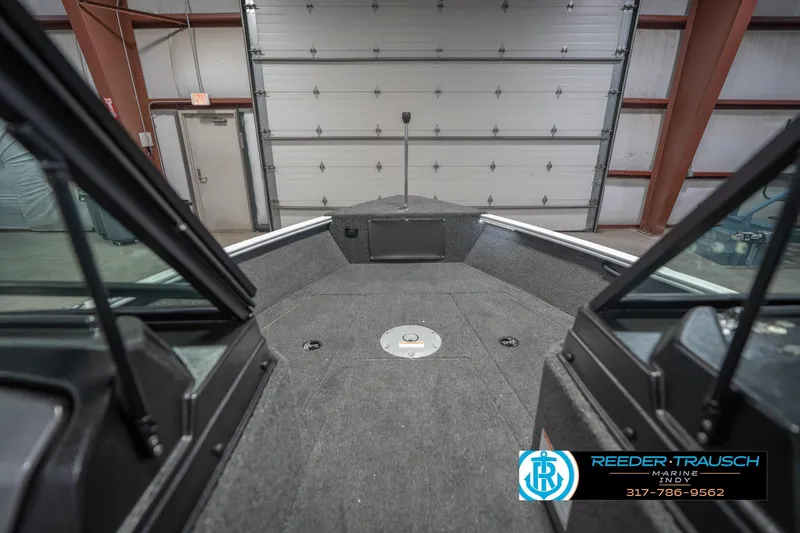 Slide: The Image of 2026 Lund 1675 Adventure Sport boat interior in a garage setting. - 33