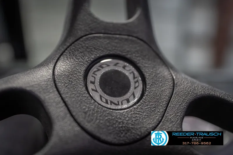 Slide: The Image of Steering wheel of 2026 Lund 1675 Adventure Sport boat, featuring textured grip. - 37