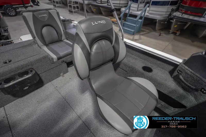 Slide: The Image of 2026 Lund 1675 Adventure Sport boat interior with gray seating and cup holders. - 44