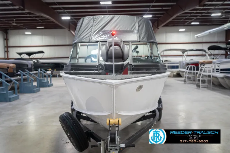 Slide: The Image of 2026 Lund 1675 Adventure Sport boat in showroom, front view with trailer. - 5