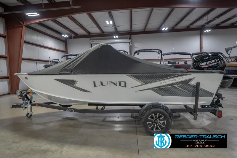 Slide: The Image of 2026 Lund 1675 Adventure Sport boat in showroom, covered and on trailer. - 65