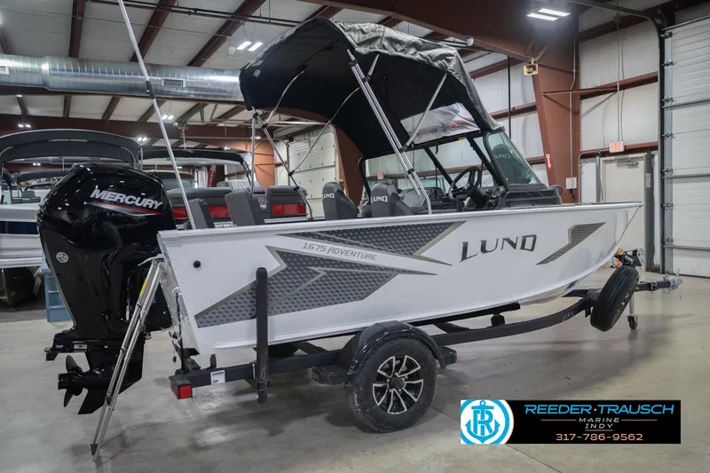 Slide: The Image of 2026 Lund 1675 Adventure Sport boat in showroom, featuring Mercury engine and sleek design. - 8
