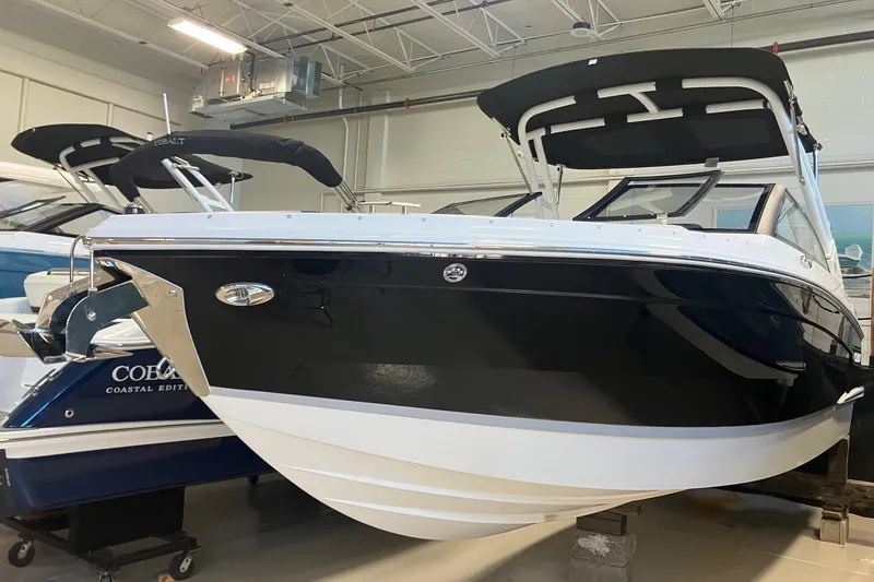 The Image of 2026 Cobalt R6 boat in showroom, featuring sleek black and white design. - 0