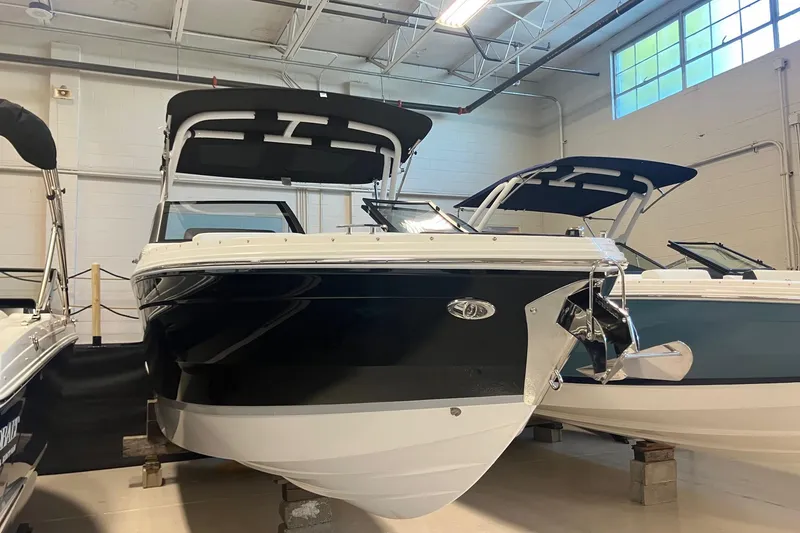 Slide: The Image of 2026 Cobalt R6 boat in showroom, featuring sleek black and white design. - 1