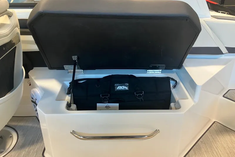 Slide: The Image of 2026 Cobalt R6 boat storage compartment with black bag inside. - 11