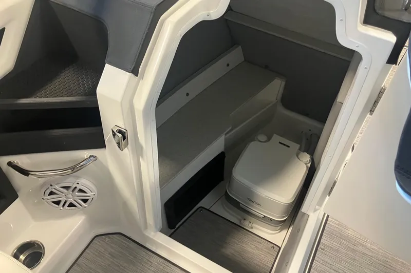 Slide: The Image of 2026 Cobalt R6 boat interior with compact toilet and storage area. - 16