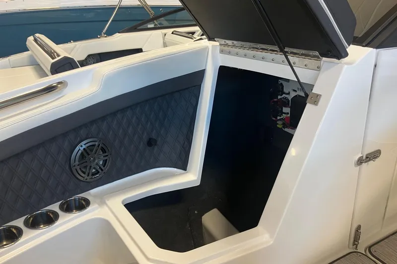 Slide: The Image of 2026 Cobalt R6 boat interior with open storage compartment and speaker. - 19