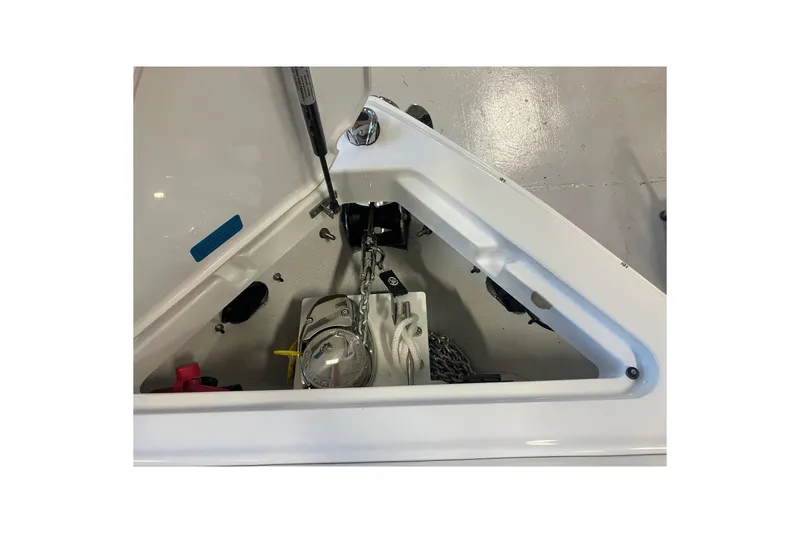 Slide: The Image of 2026 Cobalt R6 boat anchor compartment with chain and storage. - 24