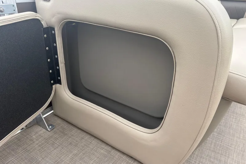 Slide: The Image of 2024 Sun Tracker SportFish 22 DLX storage compartment with open hatch, beige interior. - 17