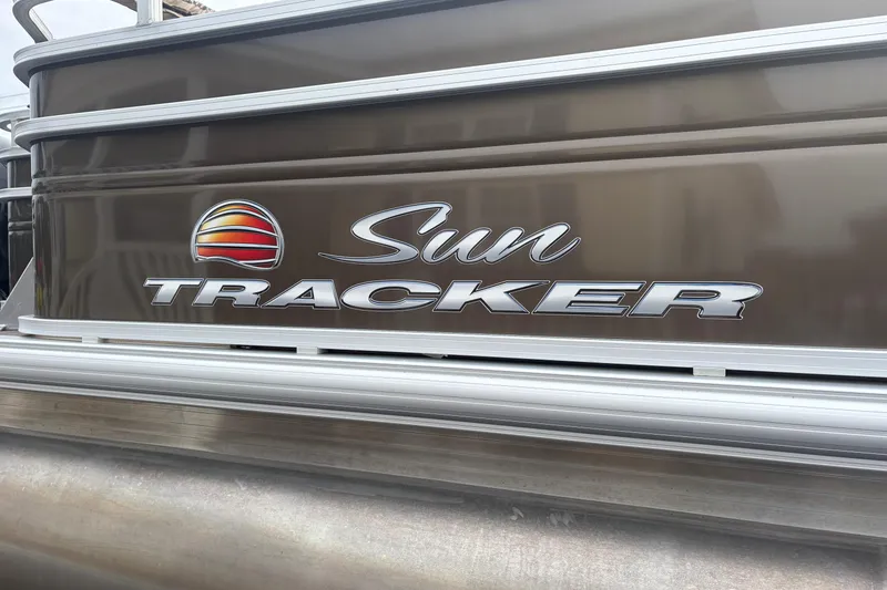 Slide: The Image of 2024 Sun Tracker SportFish 22 DLX logo on boat exterior. - 4