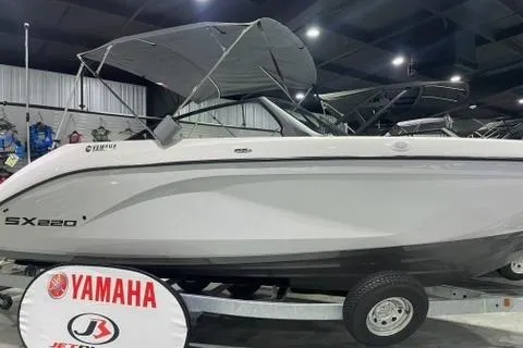 Slide: The Image of 2025 Yamaha Boats SX220 displayed indoors on a trailer. - 0