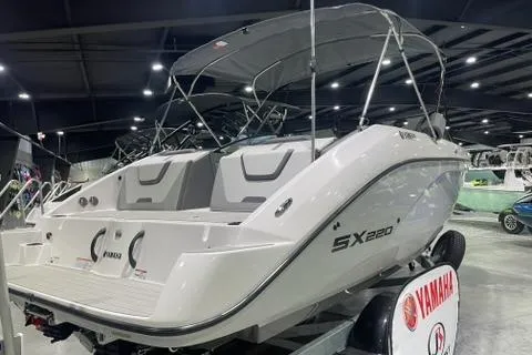 Slide: The Image of 2025 Yamaha Boats SX220 displayed indoors, showcasing sleek design and modern features. - 2