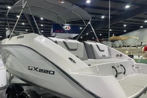 Slide: The Image of 2025 Yamaha Boats SX220, sleek design, showcased indoors with canopy and seating. - 3