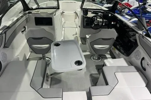 Slide: The Image of 2025 Yamaha Boats SX220 interior with seating, table, and modern dashboard. - 5