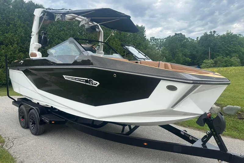 Slide: The Image of 2025 Nautique Super Air Nautique G23 boat on trailer, parked outdoors. - 11