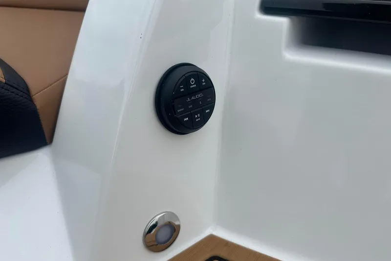 Slide: The Image of 2025 Nautique Super Air Nautique G23 audio control panel on white interior. - 12