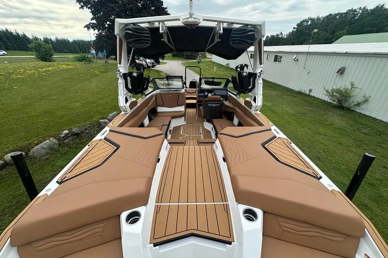Slide: The Image of 2025 Nautique Super Air Nautique G23 boat interior with tan seating and sleek design. - 13