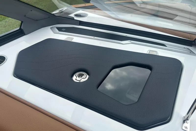 Slide: The Image of 2025 Nautique Super Air Nautique G23 dashboard with sleek black panel and chrome accents. - 22