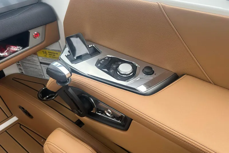 Slide: The Image of 2025 Nautique Super Air Nautique G23 interior controls with tan leather accents. - 27