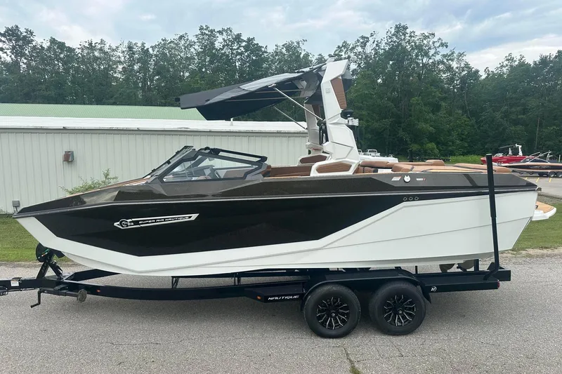 Slide: The Image of 2025 Nautique Super Air Nautique G23 boat on trailer, parked outdoors. - 3