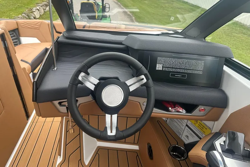 Slide: The Image of 2025 Nautique Super Air Nautique G23 dashboard with steering wheel and digital display. - 30