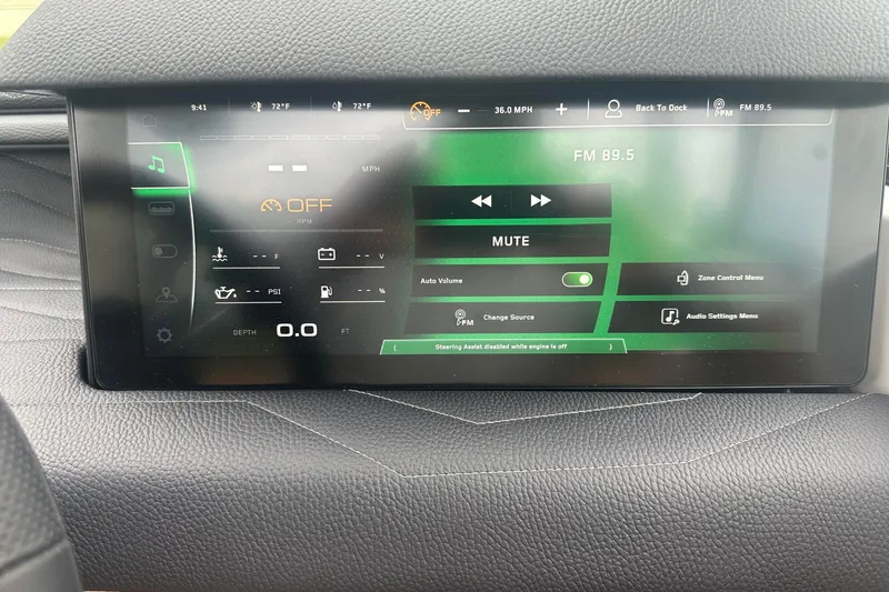 Slide: The Image of 2025 Nautique Super Air Nautique G23 dashboard display showing audio and system controls. - 33