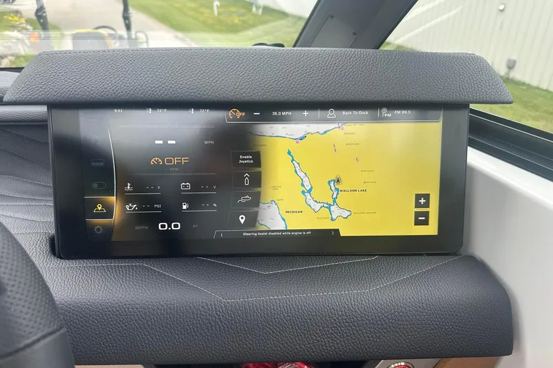 Slide: The Image of 2025 Nautique Super Air Nautique G23 dashboard with navigation display and control interface. - 36