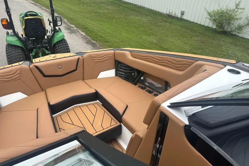 Slide: The Image of 2025 Nautique Super Air Nautique G23 boat interior with tan leather seating and modern design. - 39